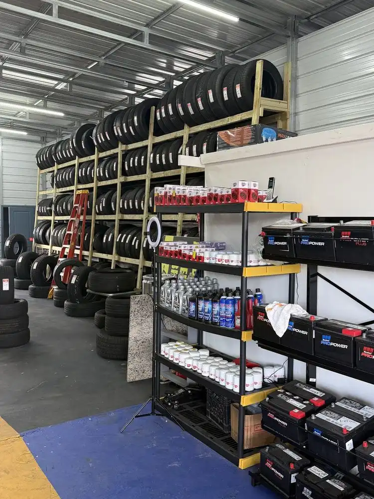 Shelves of tires, car batteries and motor oil inside a tire and auto repair shop